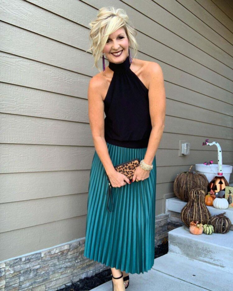Melanie in a halterneck top and pleated skirt | 40plusstyle.com