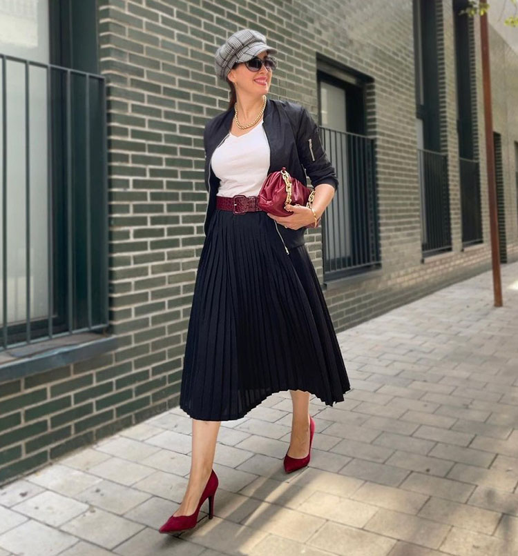 Patricia wears a pleated skirt and bomber jacket | 40plusstyle.com