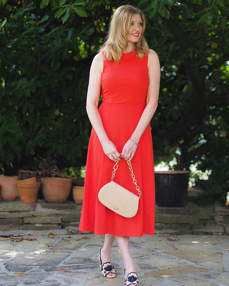 Lizzy wearing a red mid dress paired with slingback pumps | 40plusstyle.com
