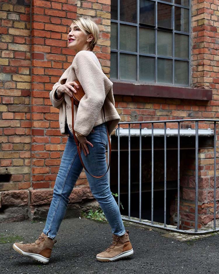 Claudia in shearling jacket, jeans and sneaker boots | 40plusstyle.com