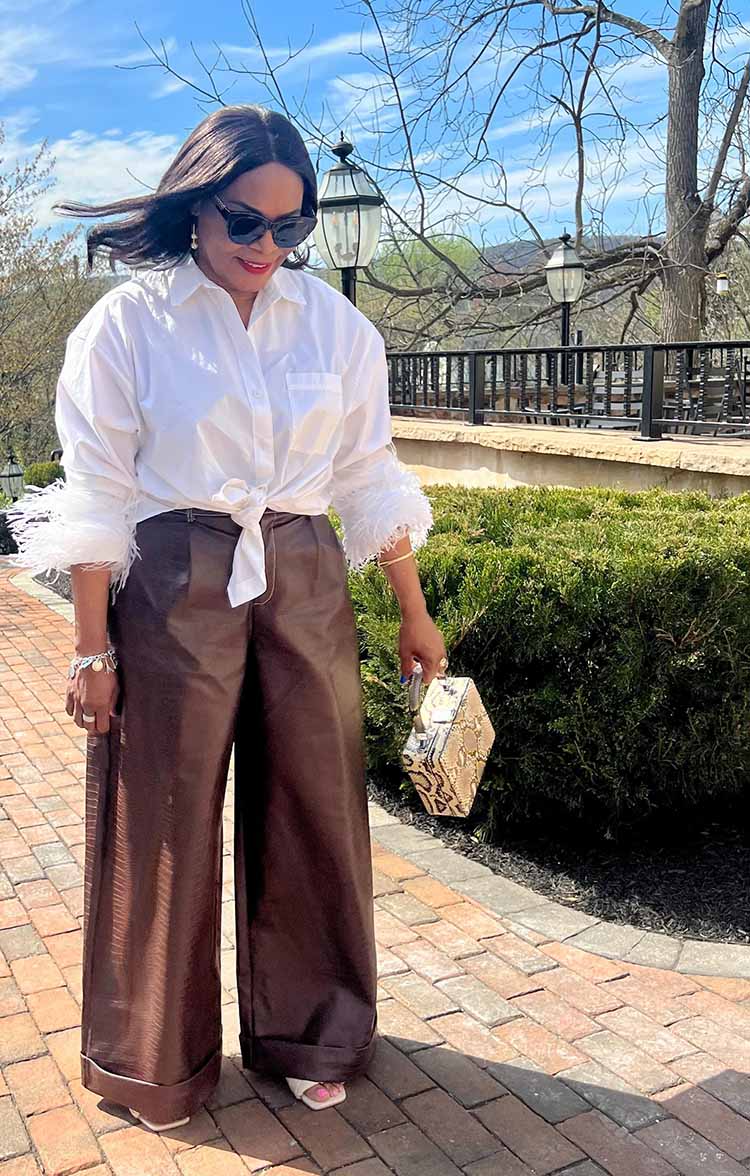 Eugenia in a white shirt and wide leg leather pants | 40plusstyle.com
