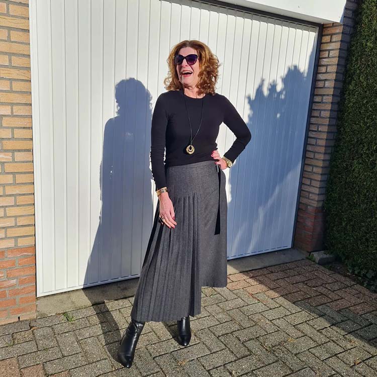 Nancy wears a pleated skirt and sweater | 40plusstyle.com