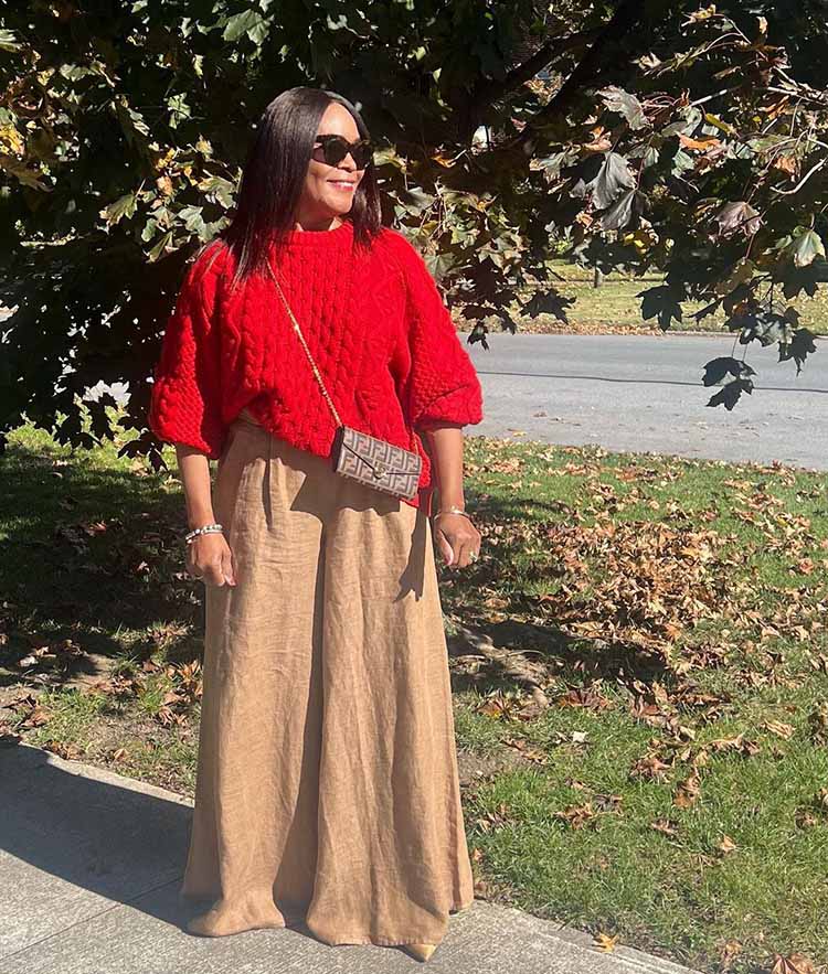 Eugenia in a red sweater and beige pants | 40plusstyle.com