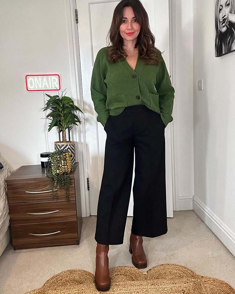 Nikki wears a green cardigan and black pants | 40plusstyle.com