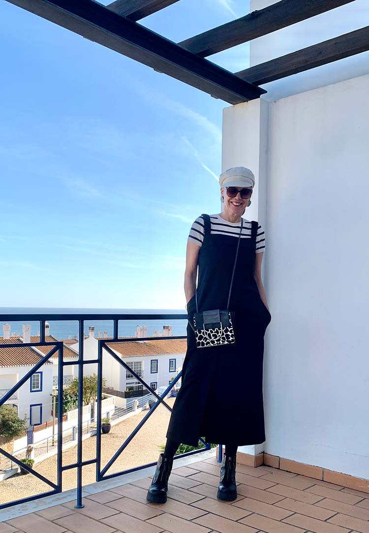 Sylvia wears a black dress and striped t-shirt | 40plusstyle.com