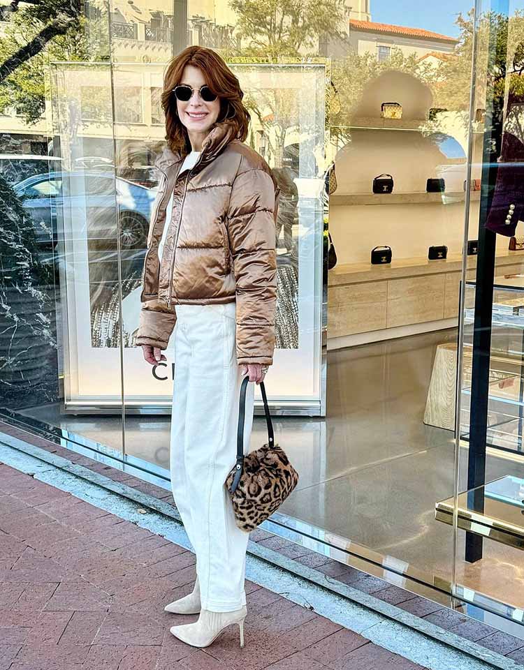 Cathy wears a bronze jacket, white jeans and booties | 40plusstyle.com
