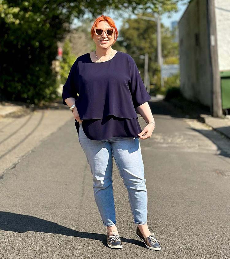 Summer tops - Kimba wears a layered top with her jeans  | 40plusstyle.com