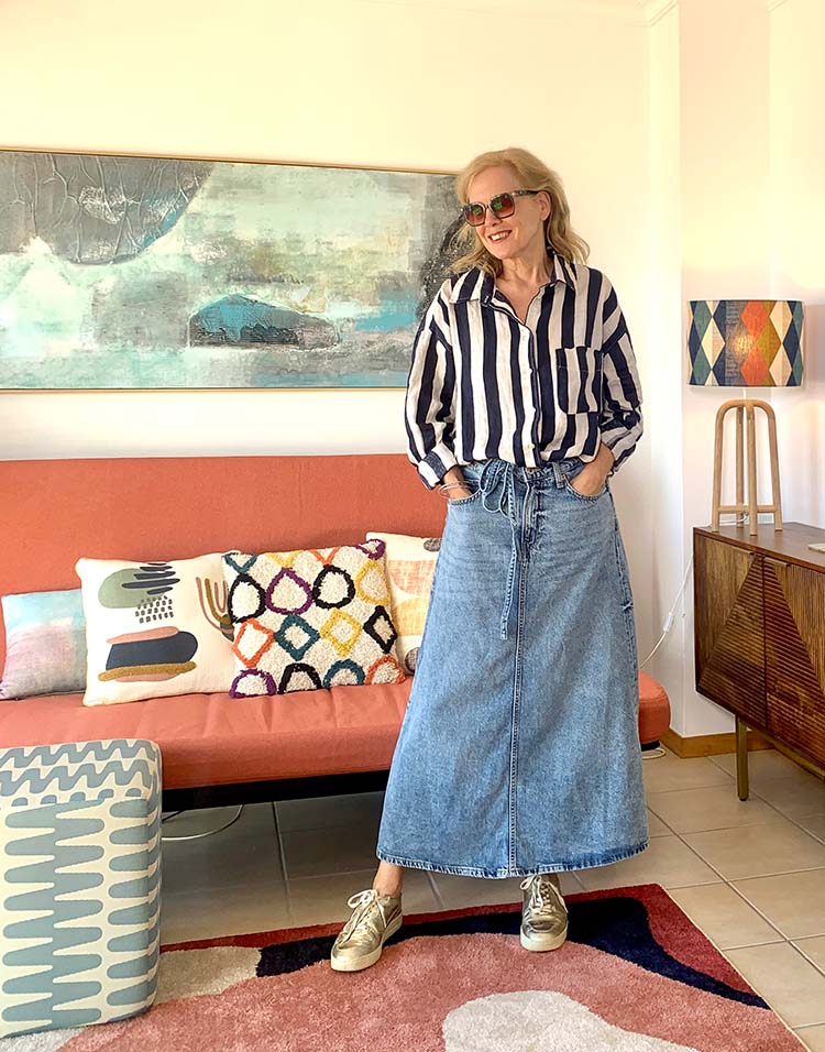 Sylvia wears a striped blouse and denim skirt | 40plusstyle.com