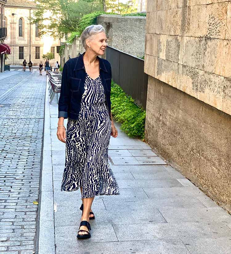 Sylvia wears a denim jacket with a print maxi dress | 40plusstyle.com