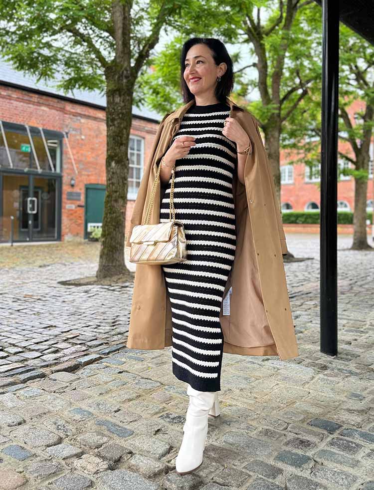 Emms wears a stripe dress and trench coat | 40plusstyles.com