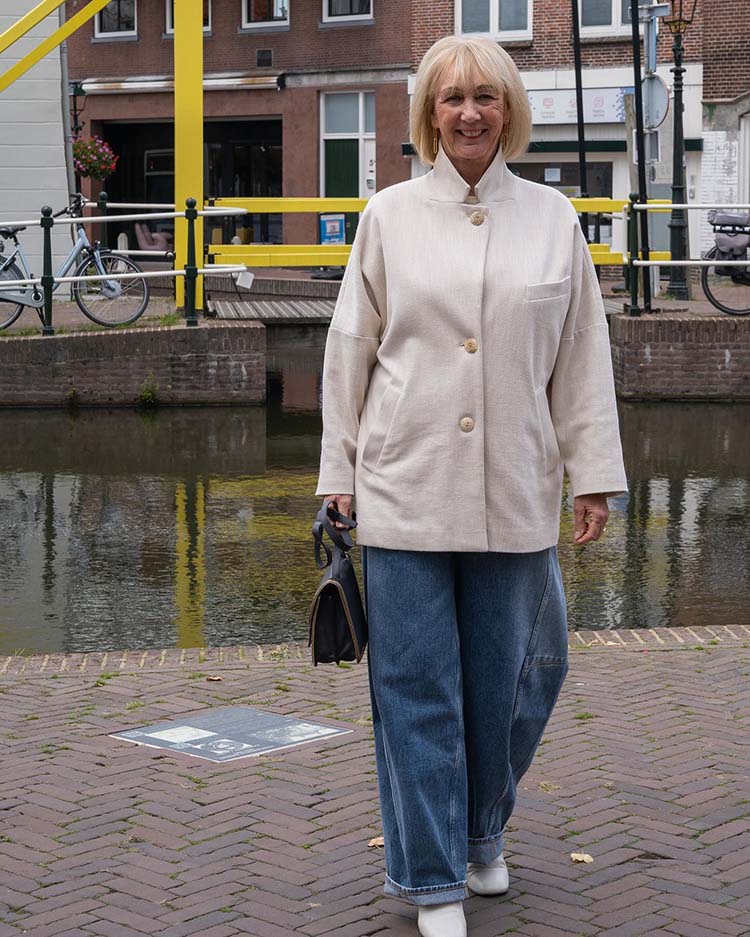 Greetje teams her jeans with a cream coat | 40plusstyle.com