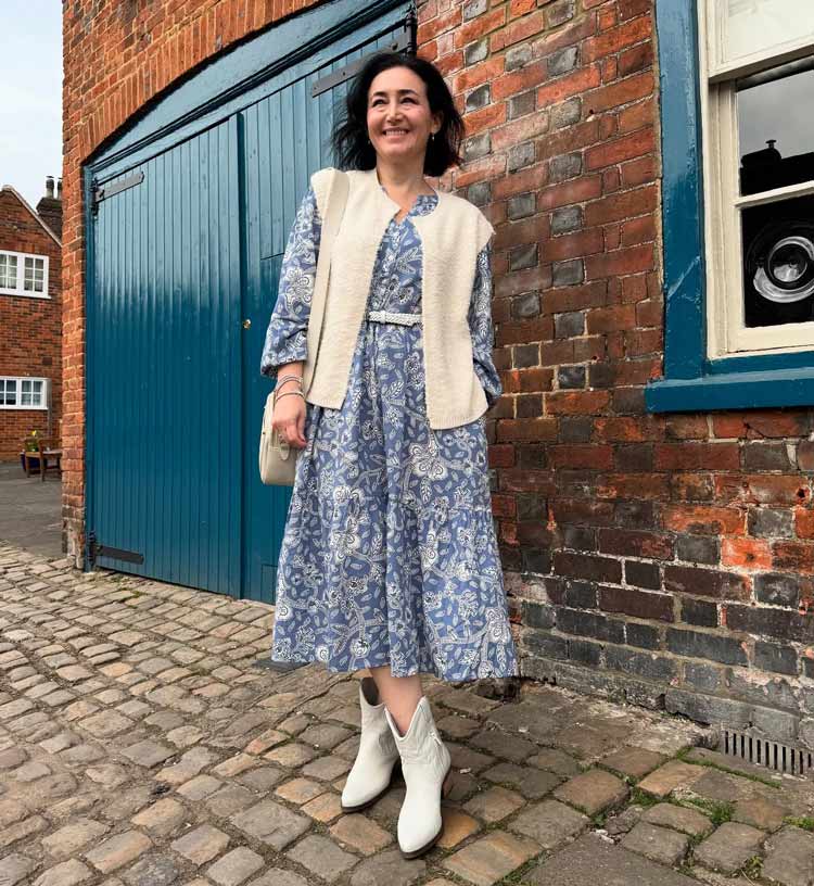 Emms wears a print dress and white boots | 40plusstyle.com