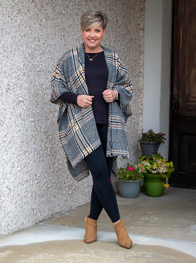 Fonda wears a black outfit and tops with a ruana | 40plusstyle.com