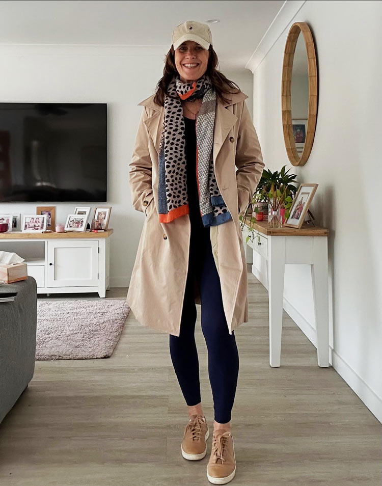 Shan wears a trench coat with her leggings and sneakers | 40plusstyle.com