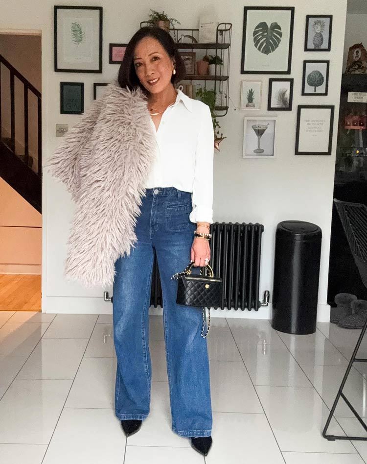 Abi wears a fluffy jacket and jeans | 40plusstyle.com