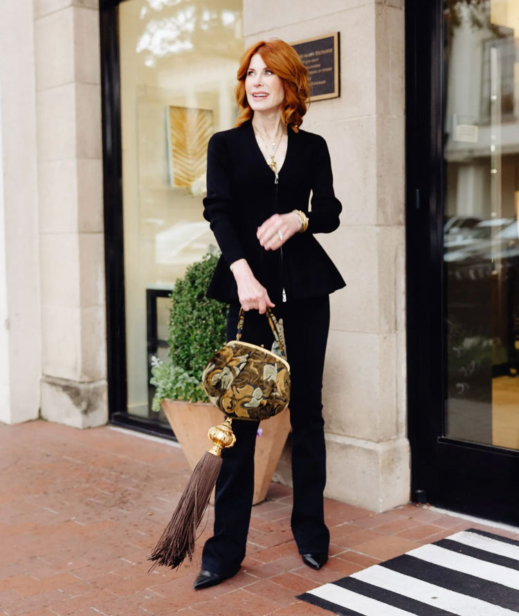 Cathy wears a black suit with floral handbag | 40plusstyle.com