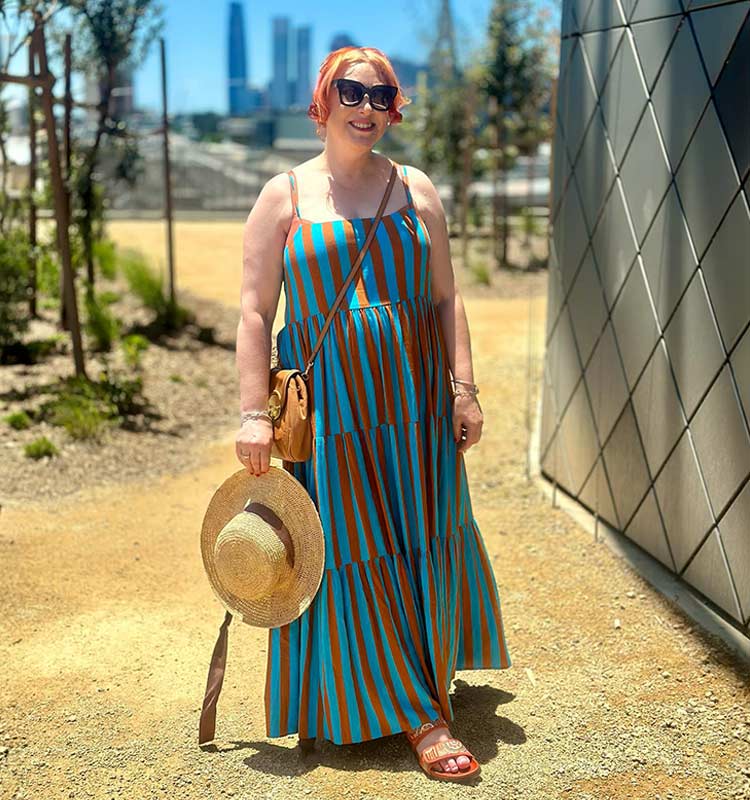 Kimba in a terracotta and turquoise tiered dress | 40plusstyle.com